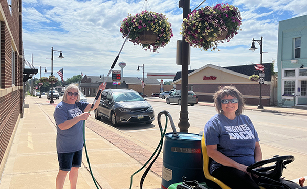 New Hampton staff Jan and Brenda helped the chamber water flowers downtown