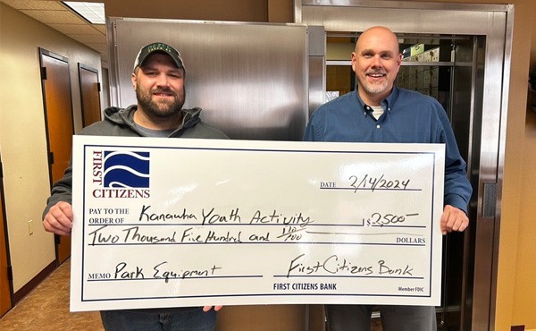 $2,500 donation to the Kanawha Youth Activity towards park equipment. Pictured is FCB employee Ryan E with Michael J.