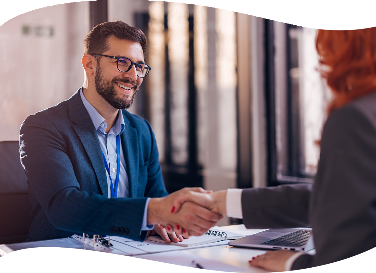 banker shaking customer hand at desk