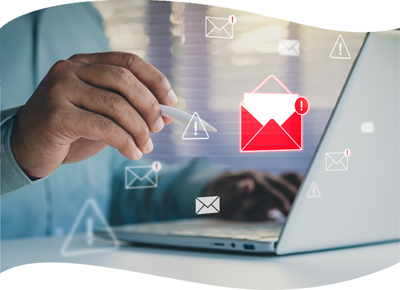 person by laptop and using smartphone with a red alert envelope icon