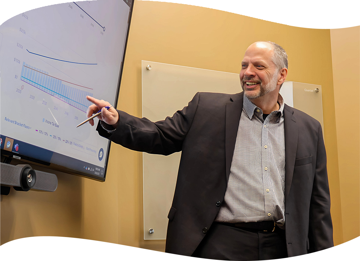 Terry Bleile, CPA (inactive), AVP, Wealth Advisor, pointing at a screen with retirement chart